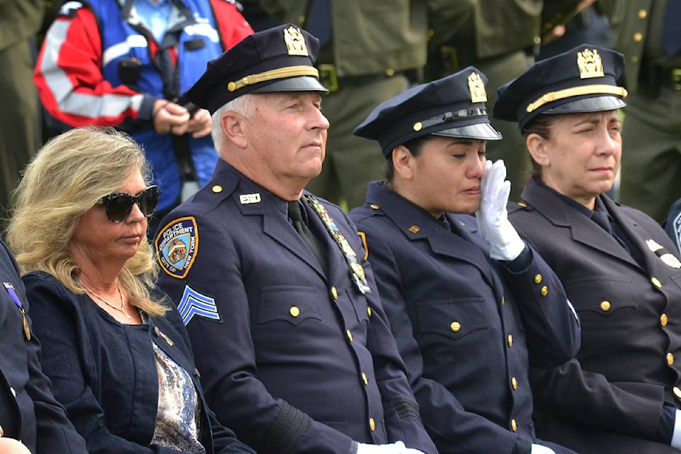 A New York Police Department officer wipes away a tear during the Sept. 11 memorial ceremony at Peace Arch Park on Wednesday. (Aaron Hinks photos)