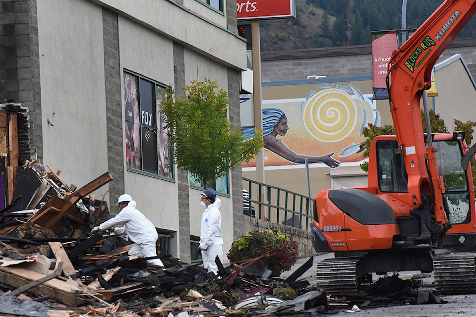 Fire investigators look for clues into Friday’s fire at Diamonds and Dust Entertainment Lounge that claimed the strip club and the café next door, New World Coffee and Tea House. Angie Mindus photos