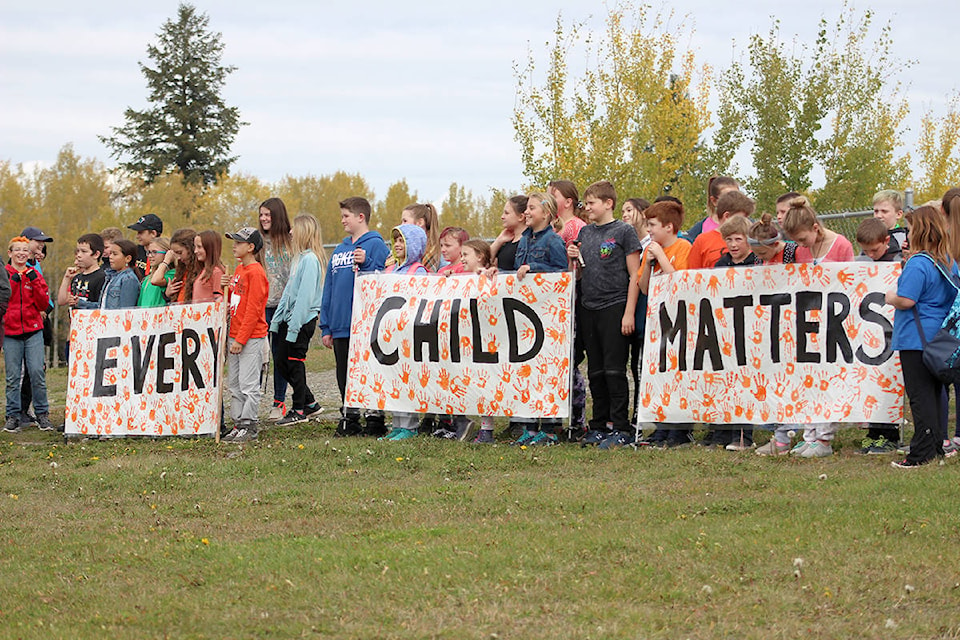 Students of School District 27 hold up signs during Orange Shirt Day outside of the South Cariboo Recreation Centre in 100 Mile House. Brendan Kyle Jure photo.