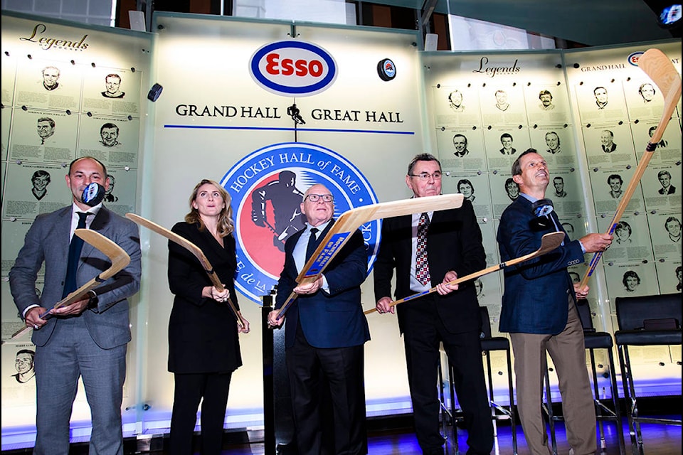Hockey Hall of Fame inductees Sergei Zubov, (left to right), Hayley Wickenheiser, Jim Rutherford, Vaclav Nedomansky and Guy Carbonneau flip pucks in the air during a ceremony in Toronto on Friday, November 15, 2019. THE CANADIAN PRESS/Nathan Denette