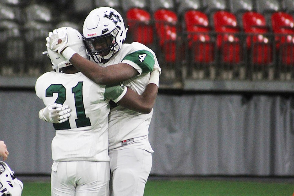 Naherny Malik embraces Reggie Elie after Lord Tweedsmuir’s 45-0 defeat in the senior AAA provincial final Nov. 30 at B.C. Place. (Photo: Olivia Johnson)