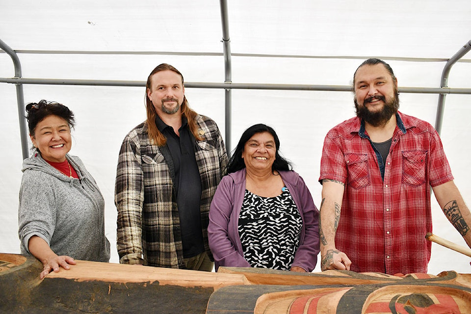 A memorial totem pole in honour of missing and murdered Indigenous women will be raised in September. Organizers Arlene Roberts, Marc Snelling and Gladys Radek along with carver Mike Dangeli are seen here with the partially-finished pole under a tent in Dangeli’s back yard on Terrace’s Southside July 16, 2020. (Jake Wray/Terrace Standard)