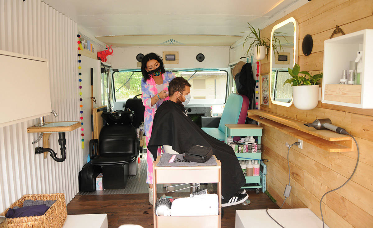 Jenny Squires cuts her husband Chris Squires’ hair on Sept. 25, 2020 in her mobile hair studio called Prime Real Estate Salon. (Jenna Hauck/ Chilliwack Progress)