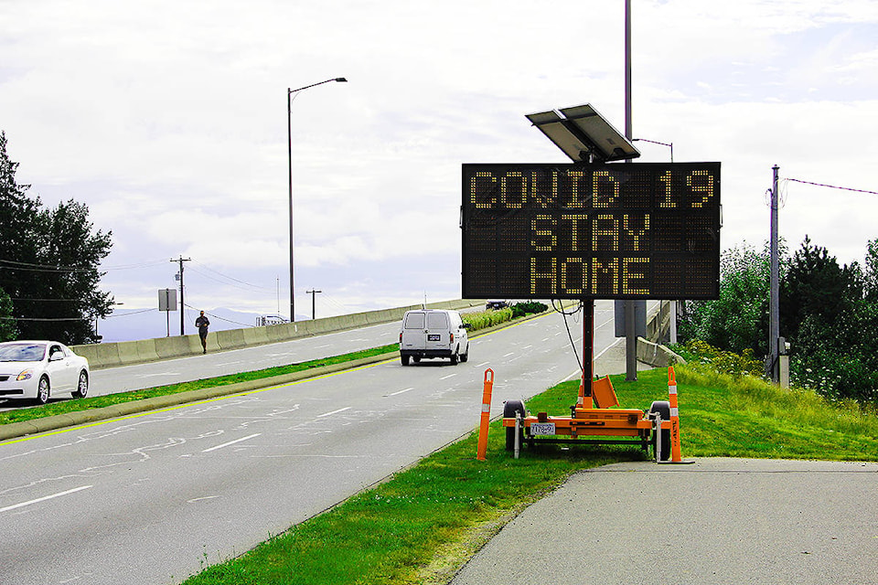 A COVID-19 warning sign on the Surrey-Langley border. As cases rise, but deaths fall lower, is it time to rethink our pandemic response? (Photo: Malin Jordan)
