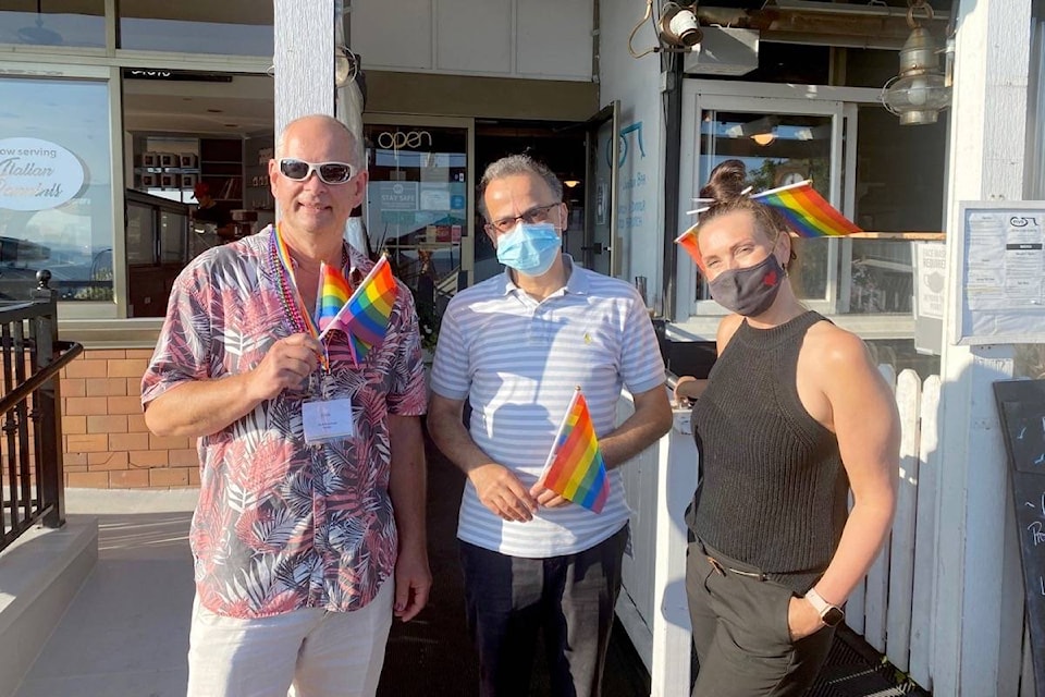 White Rock Pride Society president Ernie Klassen poses with Gus Rachid and Kimberley Pritchard outside FIVE Kitchen Oyster Bar Wednesday (July 14). (Contributed photo)