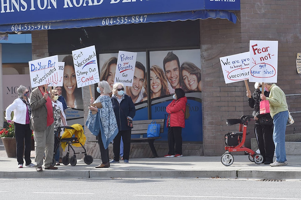 A group of about a dozen Semiahmoo Peninsula seniors rallied in support of COVID-19 vaccinations Friday afternoon in White Rock. (Nick Greenizan photo)