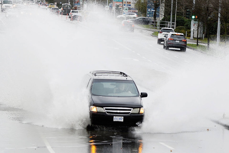 A van plows through a puddle on 152 Street near 154A Avenue Monday afternoon. (Aaron Hinks photo)