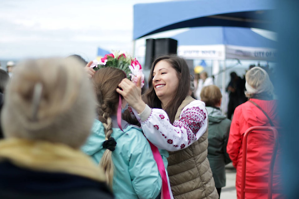 Marianna Volynets places a vinok, a traditional Ukrainian wreath, on a woman’s head during the ‘Peace Walk for Ukraine’ in White Rock Saturday morning (April 2, 2022). (Photo: Lauren Collins)