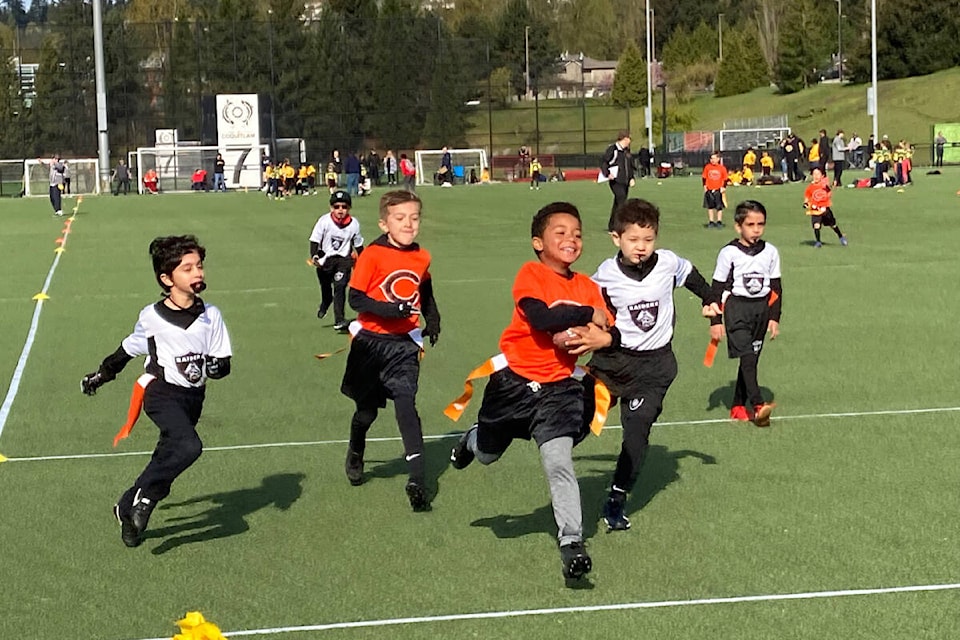 Kids from the Cloverdale Community Football Association (orange shirts) play flag football in their first jamboree of the season and their first jamboree in two years. (Photo submitted: Yeera Sami)