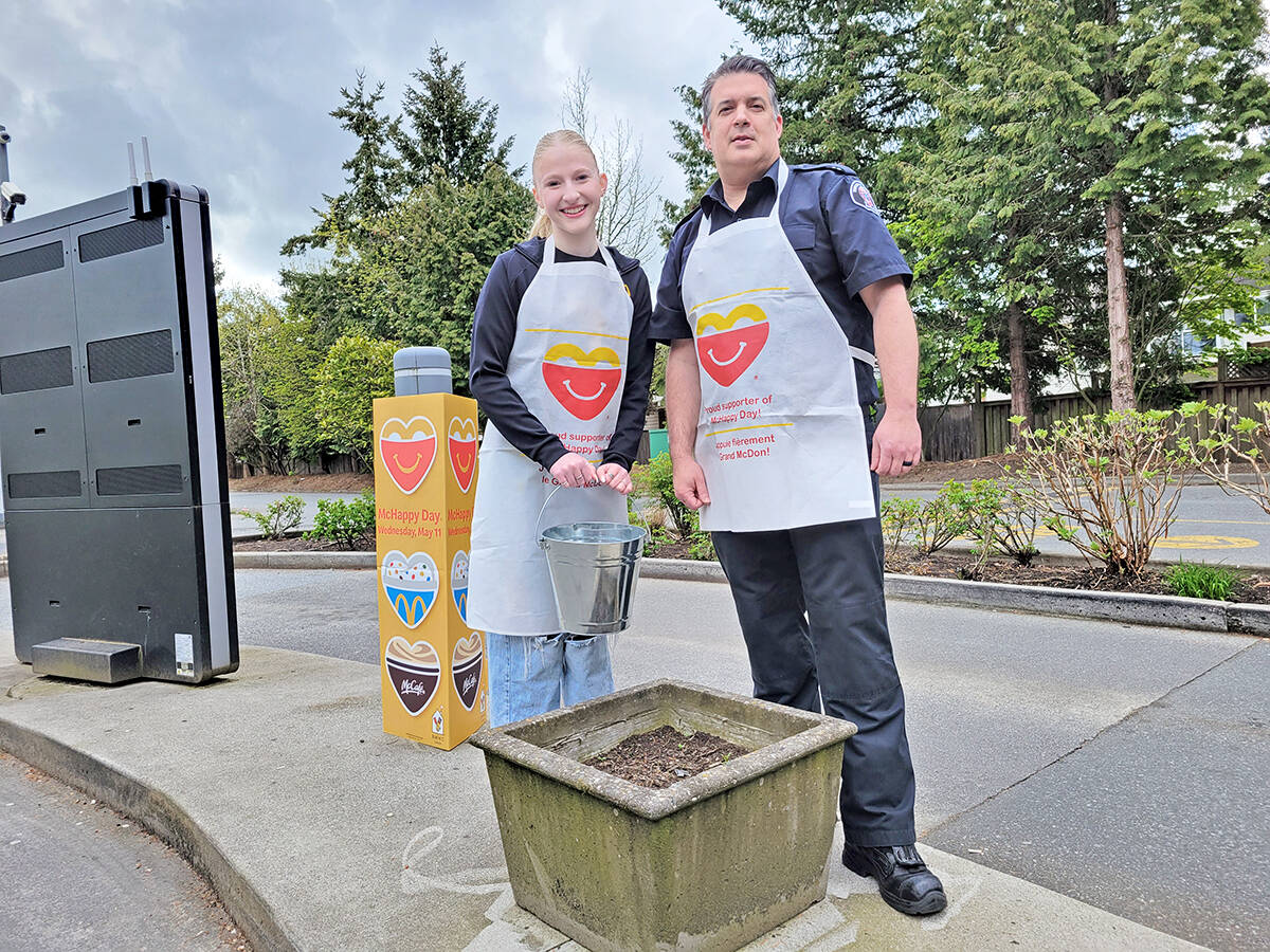 Brooklyn Mace and Rob Kennedy were collecting contributions at the Langley Murrayville McDonalds drive-through on McHappy Day. Money was being raised for the Langley Foundry and Ronald McDonald House B.C. (Dan Ferguson/Langley Advance Times)