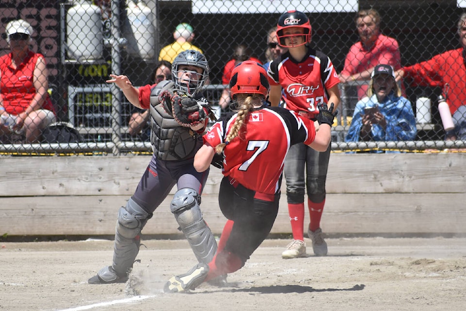 After smashing a hit down the right-field line, Cloverdale Fury ‘06 baserunner Ella Booth is thrown out at home against the White Rock Renegades ‘06 during a Showcase Gold division game Thursday at the Canada Cup. (Nick Greenizan photo)