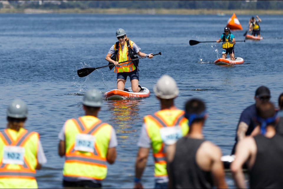 Paddlers makes their way toward the start/finish line at Surrey Hospital Foundation “Champion of the Crescent” third annual stand up paddle board charity event at Blackie Spit Park at Crescent Beach in in Surrey on Saturday, July 23, 2022. The event supports youth mental health programs, with proceeds going towards renewing the outdoor courtyard used by youth in the adolescent day treatment program in Surrey. (Photo by Anna Burns/Black Press Media)