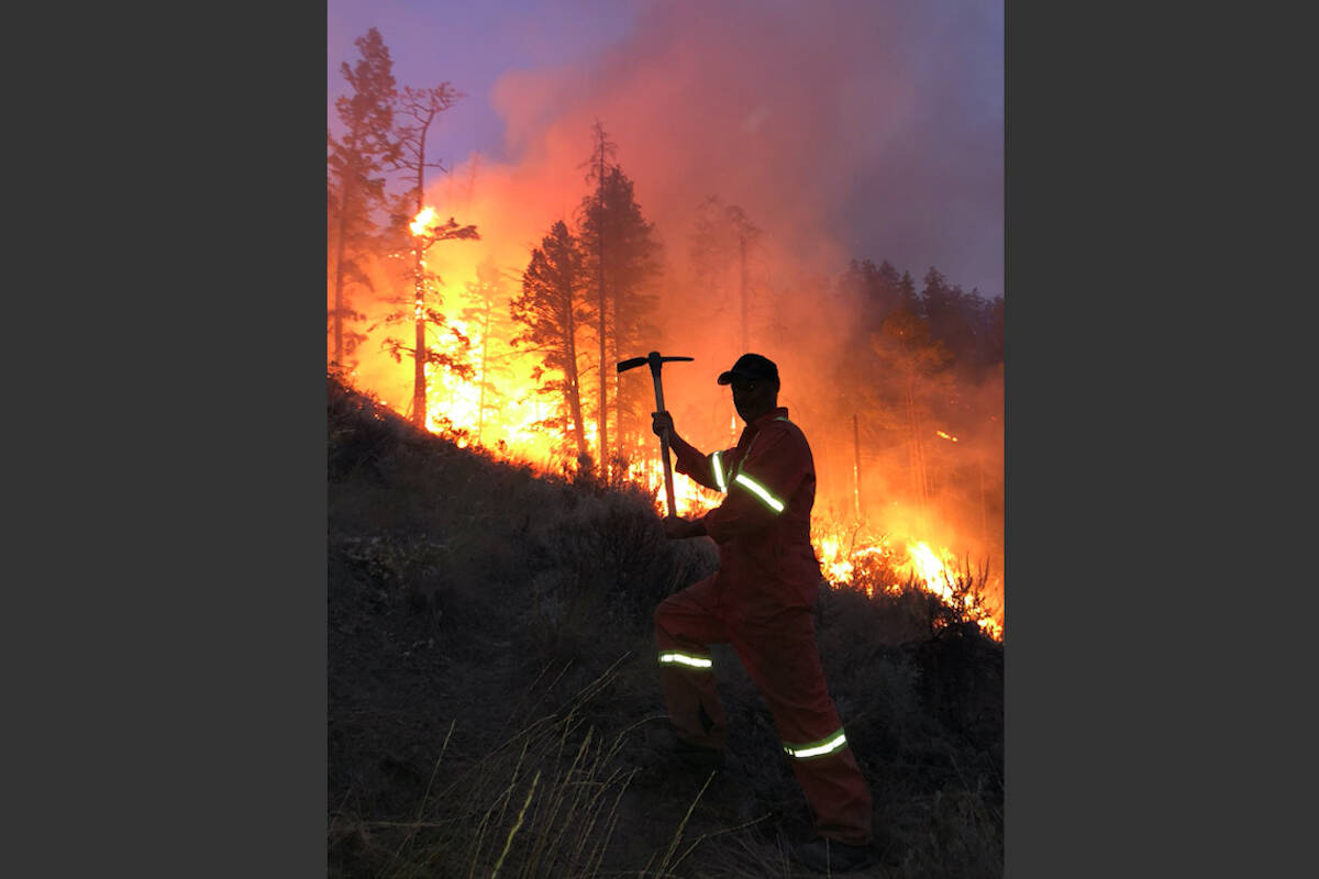 Clay Smith, father, digging a trench to prevent encroachment of the fire (Caillum Smith/Preserved Light Photography)