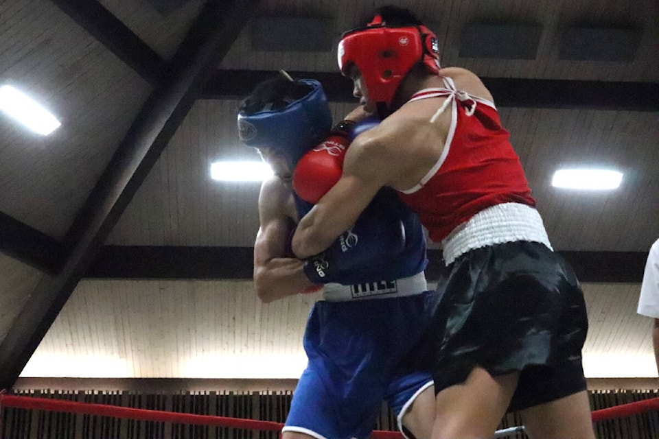 Ejaz Mohammed from Surrey’s Port Kells Boxing Club (left) and Rome Macalalag from Vancouver’s Diaz Boxing land blows in-close during their main event bout at the Ian Gibson Tribute Boxing Show Saturday, Aug. 20, at the Vernon Recreation Centre. (Roger Knox - Morning Star)