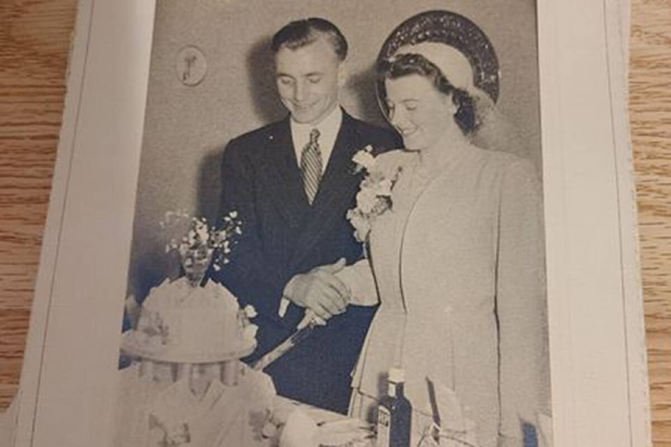 A couple’s wedding photo of them cutting their wedding cake was one of the photos found in the deep corner of a White Rock home. (Contributed photo)