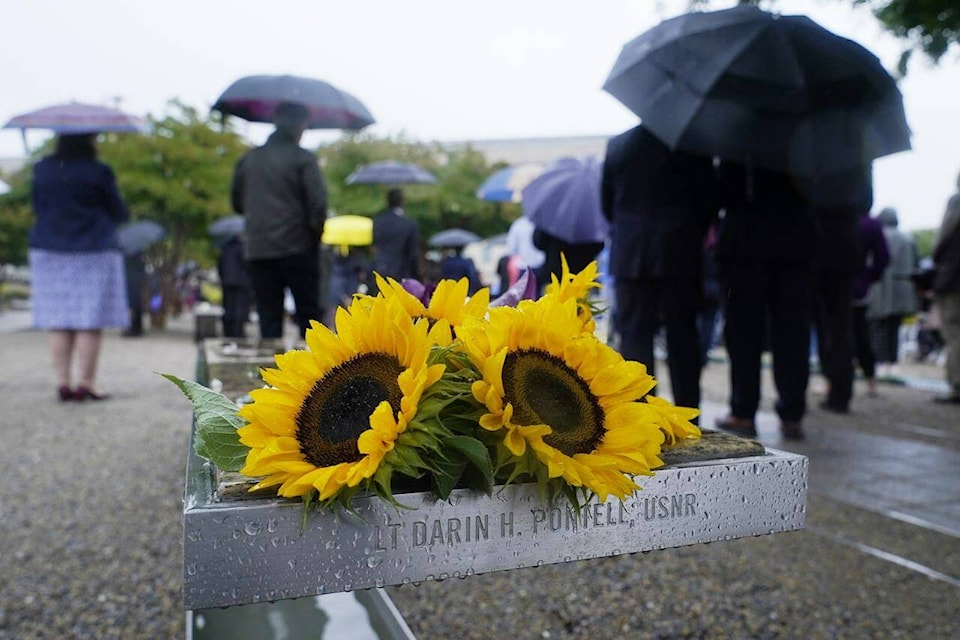 Flowers are visible on one of the benches at the National 9/11 Pentagon Memorial outside the Pentagon in Washington, Sunday, Sept. 11, 2022, during a ceremony to honor and remember the victims of the September 11th terror attack. (AP Photo/Susan Walsh)