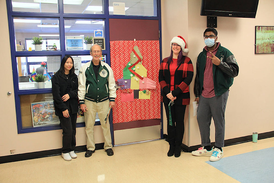 Students, staff, and alumni judge the annual “Christmas Doors Contest” Dec. 14 at Lord Tweedsmuir. Pictured (from left): student Summer Tumulak, alumnus Alan Clegg, vice-principal Danielle Garbe, and student Santhosh Senthil. (Photo: Malin Jordan)