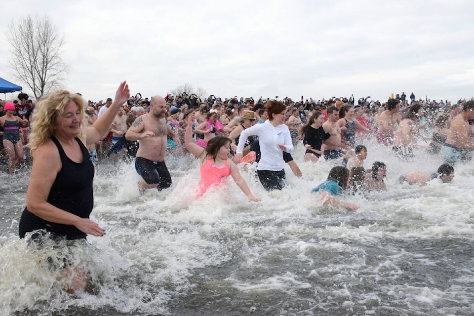 More than 400 people plunged into the frigid waters of Boundary Bay at Centennial Beach on Sunday, Jan. 1 to celebrate the start of 2023 with the return of Delta’s Polar Bear Swim after a two-year hiatus due to COVID-19 restrictions. (James Smith photo)