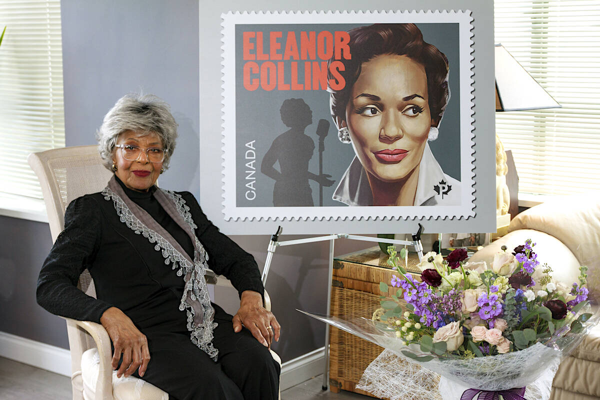 Eleanor Collins with a poster of Canada Posts commemorative stamp in 2022. (File photo)