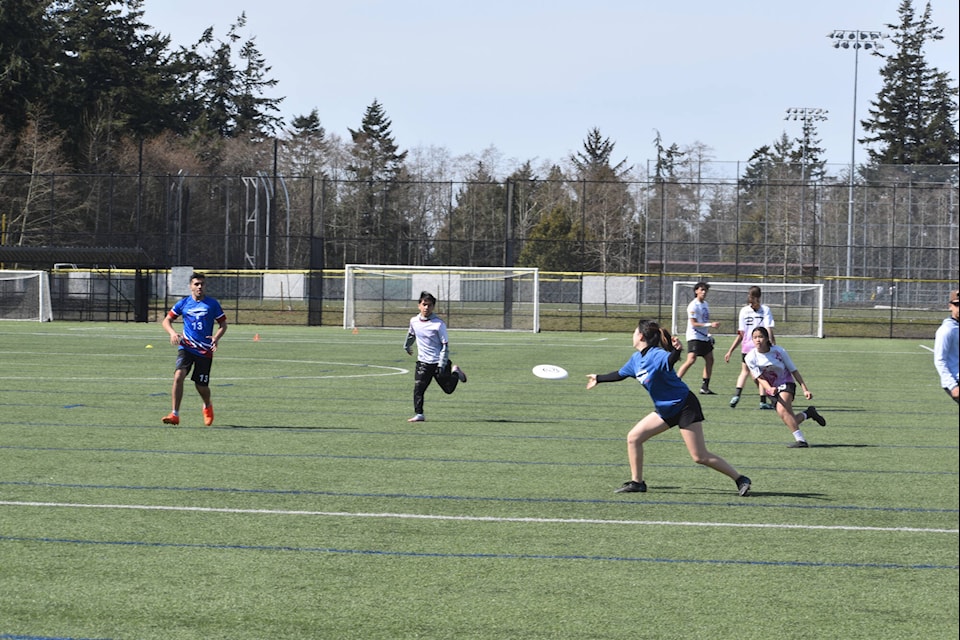 Semiahmoo Secondary students (in blue) play Kwantlen Park Secondary at the Myles Winch Ultimate Frisbee Tournament in South Surrey Wednesday, held in honour of longtime teacher and coach Myles Winch, who died in 2016. 16 Lower Mainland school teams participated in the event, which raises funds for Winch’s Go Outside and Play bursary. (Tricia Weel photo)