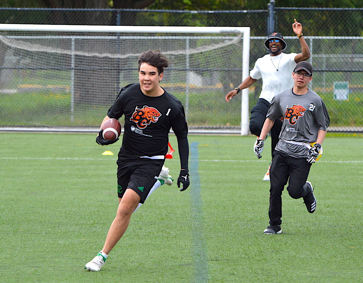 A Chilliwack Hornets player carries the ball for a touchdown against Surrey Dawgs during the BC Lions Indigenous Youth flag football tournament at Tom Binnie Park in Surrey on Sunday, April 30, 2023. (Photo: Tom Zillich)