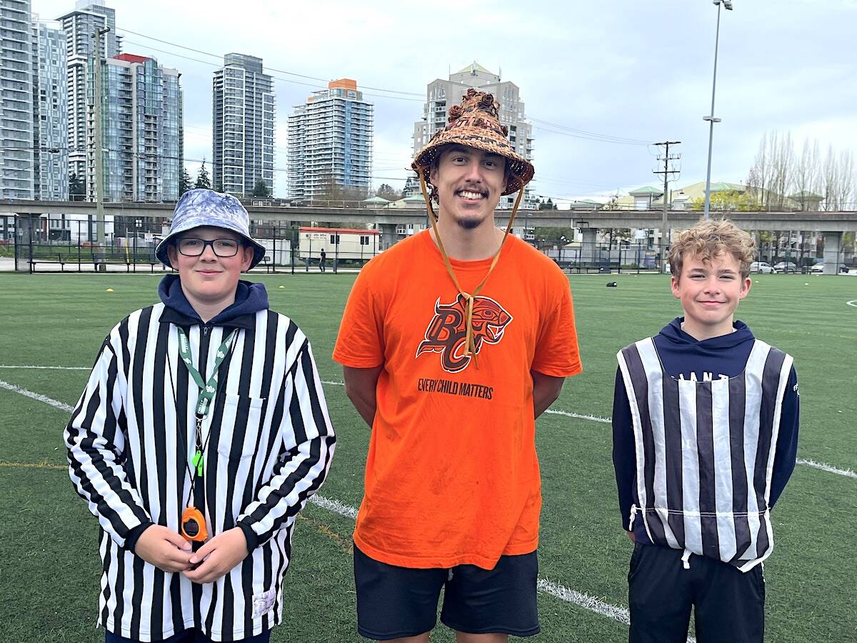 BC Lions player Jacob Firlotte flanked by a pair of young referees during the BC Lions Indigenous Youth flag football tournament at Tom Binnie Park in Surrey on Sunday, April 30, 2023. (Submitted photo)