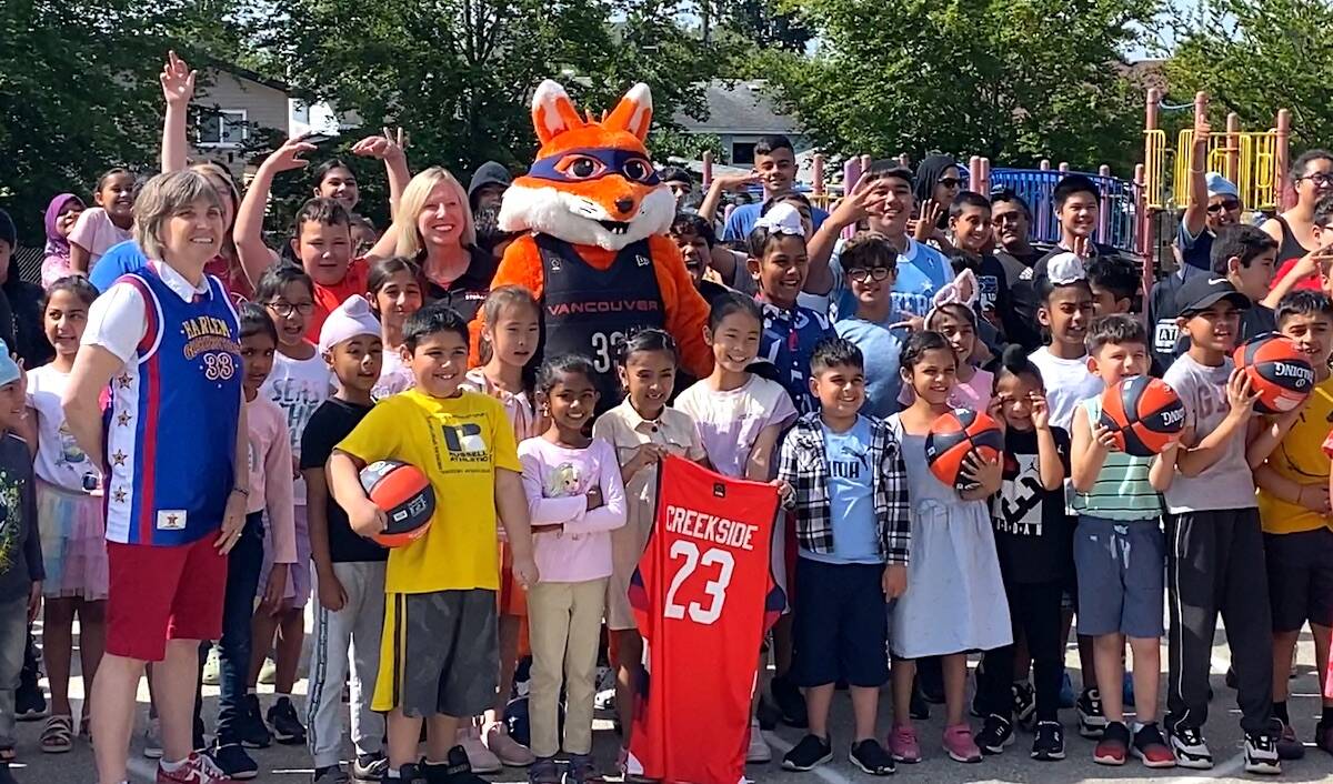 Group photo for Vancouver Bandits pro basketball team mascot Berry the Bandit with kids and teachers at Creekside Elementary during a visit to the Surrey school on Thursday, June 8, 2023. (Photo: Tom Zillich)