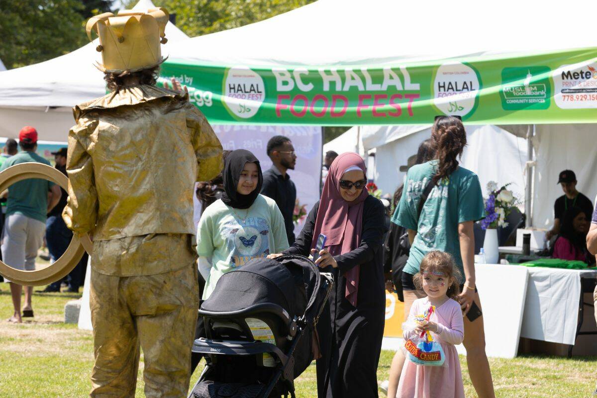 A young child watches a performer at the BC Halal Food Fest on July 8, 2023 in Holland Park. Bolow and Abdal Salam were volunteering at the food fest. (Photo: Anna Burns)