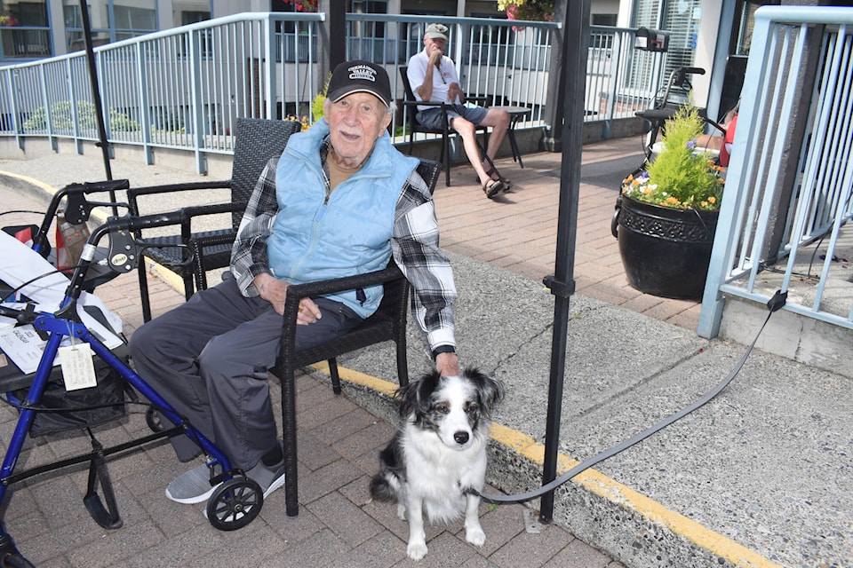 Harold Zelt with Penny outside White Rock Seniors Village on Sunday. People were encouraged to bring their pups by the residence for a chance to appear in Zelt’s fourth Dogs of White Rock calendar, which has raised $4,700 for the BC SPCA so far. (Tricia Weel photo)