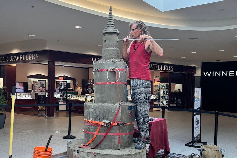 Sandcastle artist, Craig Mutch, works on his eight-foot-tall sandcastle. Located inside Semiahmoo Shopping Center, near Winners, the sculpture is to remain on display until Aug. 31, 2023. (Contributed photo)
