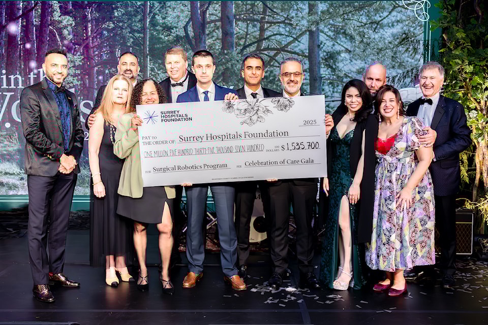 A giant cheque at Surrey Hospitals Foundation’s "Tales in the Woods"-themed Celebration of Care Gala at Aria Convention Centre in Surrey on Saturday, Feb. 22, 2025. Pictured from left are Harp Dhillon, Paul Deol, Nancy McNeill, Jacy Wingson, Larry Thomas, Dr. Alex Butskiy, Dr. Randy Gill, Dr. Ahmad Ashrafi, Jennifer Hochstein, David McFarlane, Nicole Robson and Ralph Berezan.