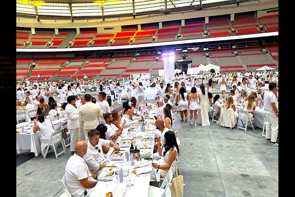 Crowd and tables at the Dîner en Blanc Vancouver event at BC Place Stadium on Thursday, Aug. 15, 2024.