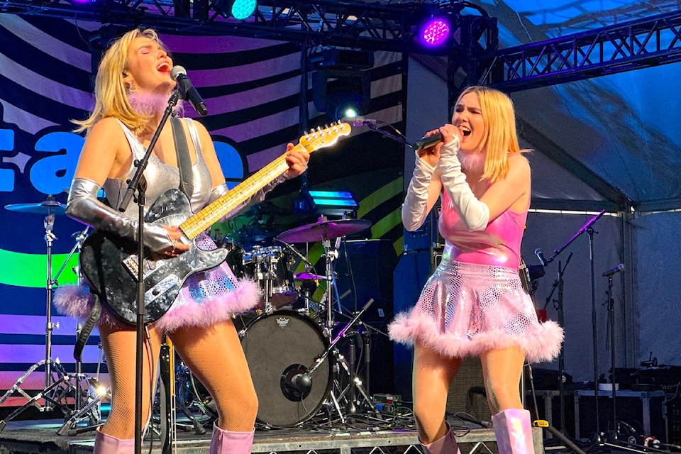 The twin Finn-Morris sisters of Fionn (Brianne, left, on guitar, and Alanna, holding a microphone) perform during the Let’s Hear It BC JUNOS Plaza Party at Surrey Civic Plaza on Saturday, March 15, 2025. 