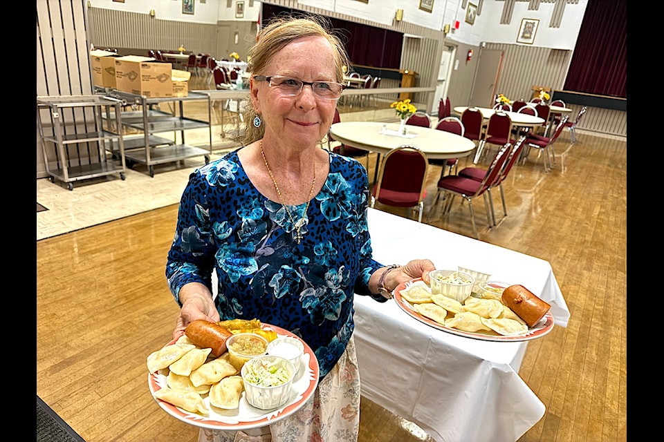 Evelyn Smoliak serves plates of perogies at the monthly suppers at Ukrainian Cultural Centre in Surrey.