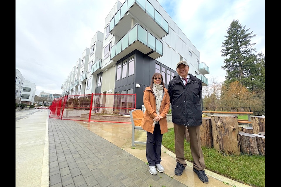 Sales agent Czarina Chan and developer Eddie Chiu outside the Creekside Terrace townhouse project in Surrey on Jan. 11, 2025.