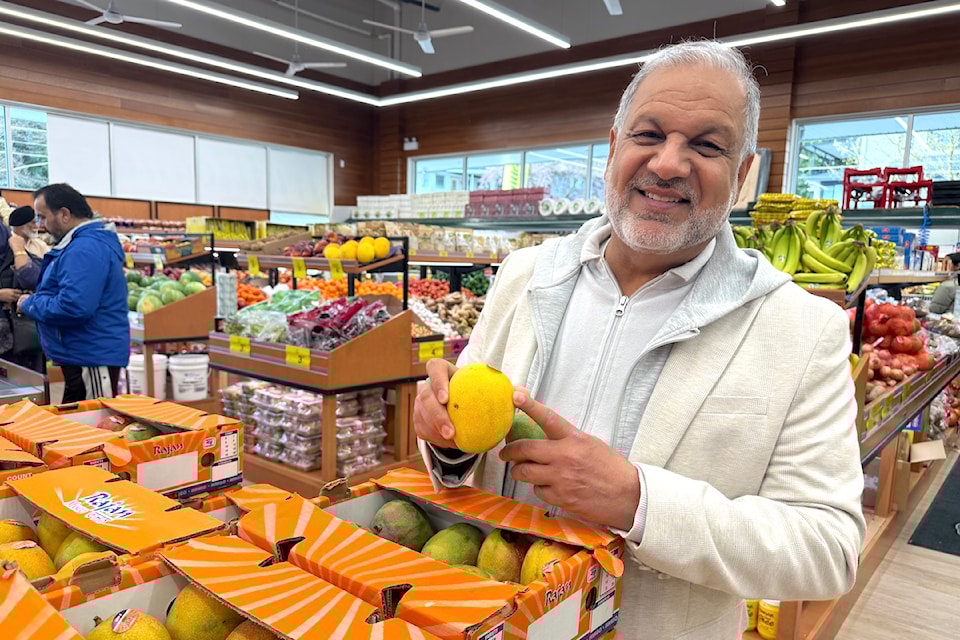 Tony Singh with a box of mangoes at his newest Fruiticana grocery store in Newton, on 64 Avenue near 132 Street, Surrey.