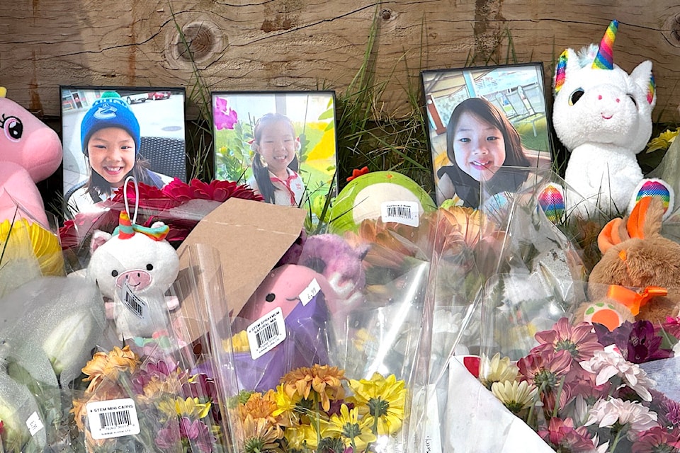 Photos and flowers at a roadside memorial for young crash victim Jayla Chang on Tuesday, April 15, 2025, on 164 Street south of 108 Avenue in Surrey.