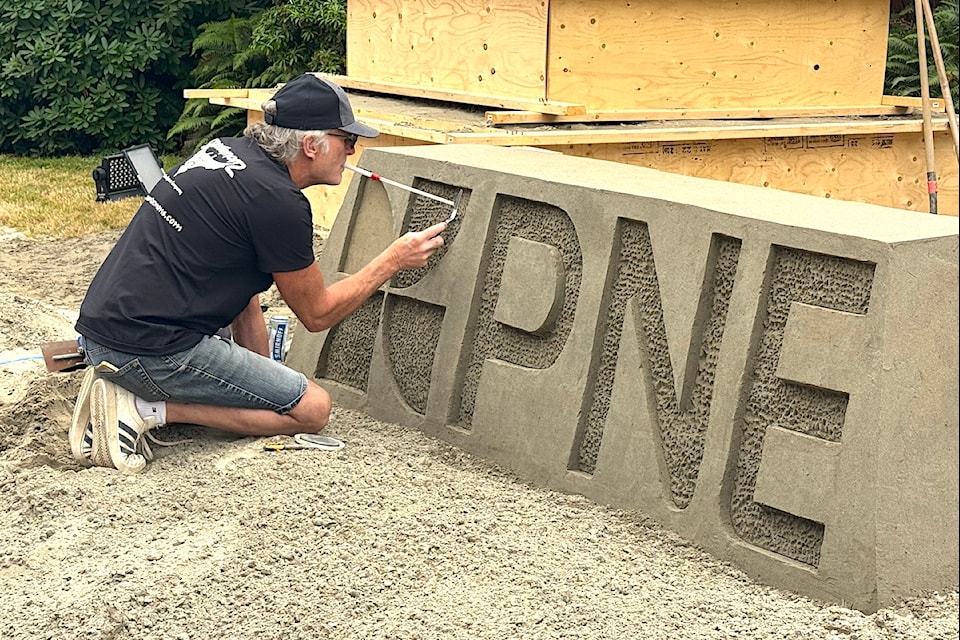 Langley-based sand artist Bruce Waugh creates a PNE sculpture at the fair site in Vancouver on Aug. 14, 2025.