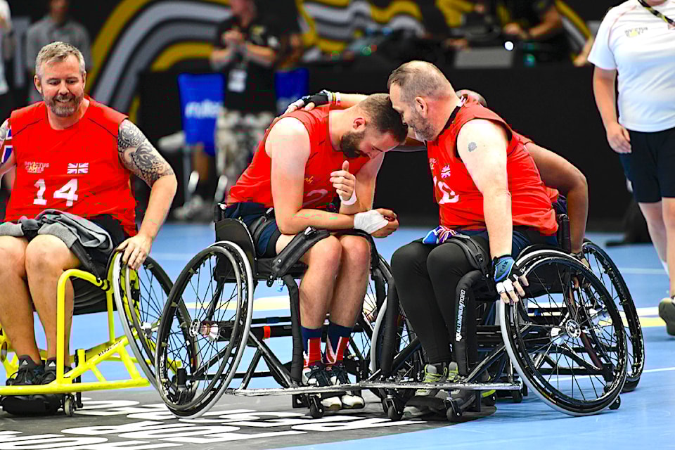 Competitors of Team United Kingdom celebrate as they win third place of the wheelchair basketball tournament at Centre Court, Merkus Spiel-Arena during the 2023 Invictus Games in Düsseldorf, Germany, on Sept. 13, 2023.