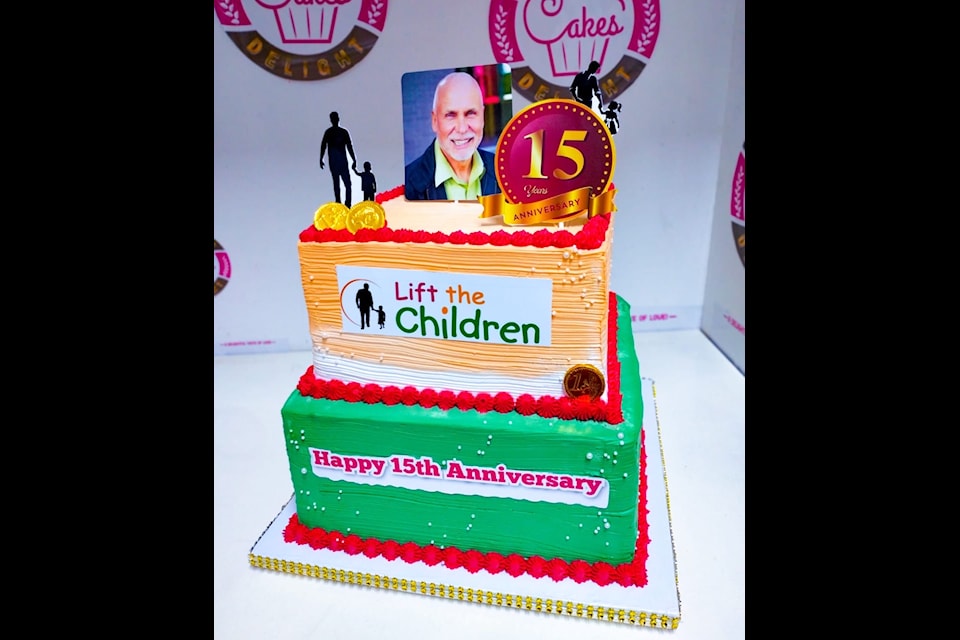 Charity founder John Volken's photo atop a 15th-anniversary cake celebrating Surrey-based Lift the Children.