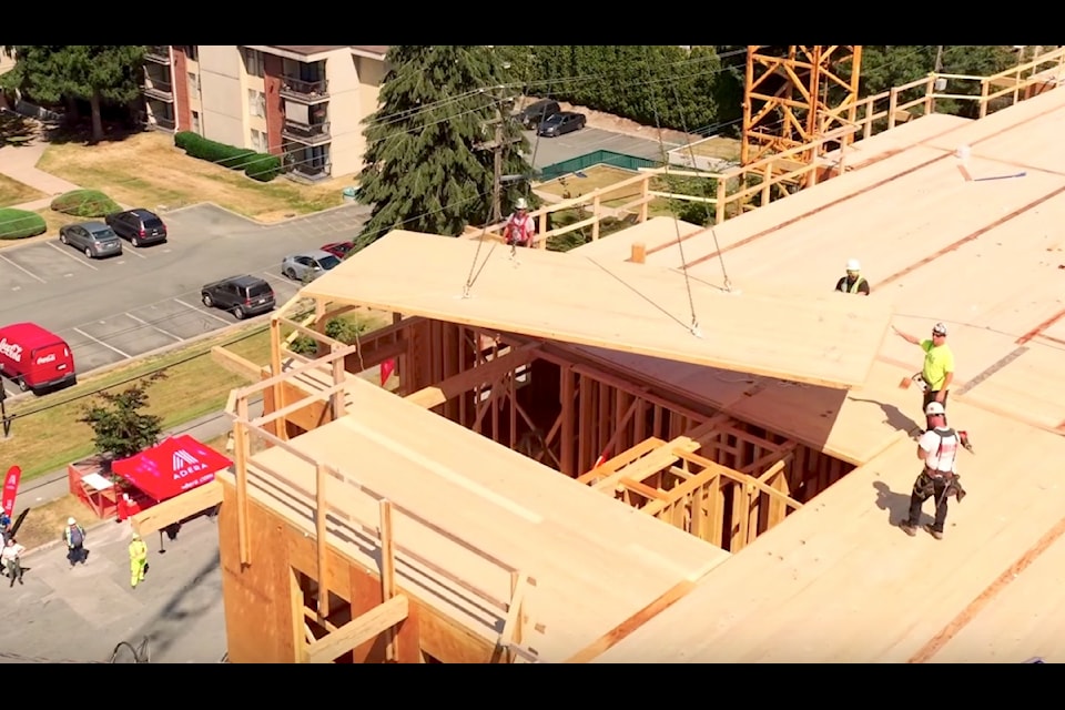 Final panel of cross-laminated timber (CLT) lifted into place on the roof of Adera's PURA residential development in Surrey on July 23, 2024.