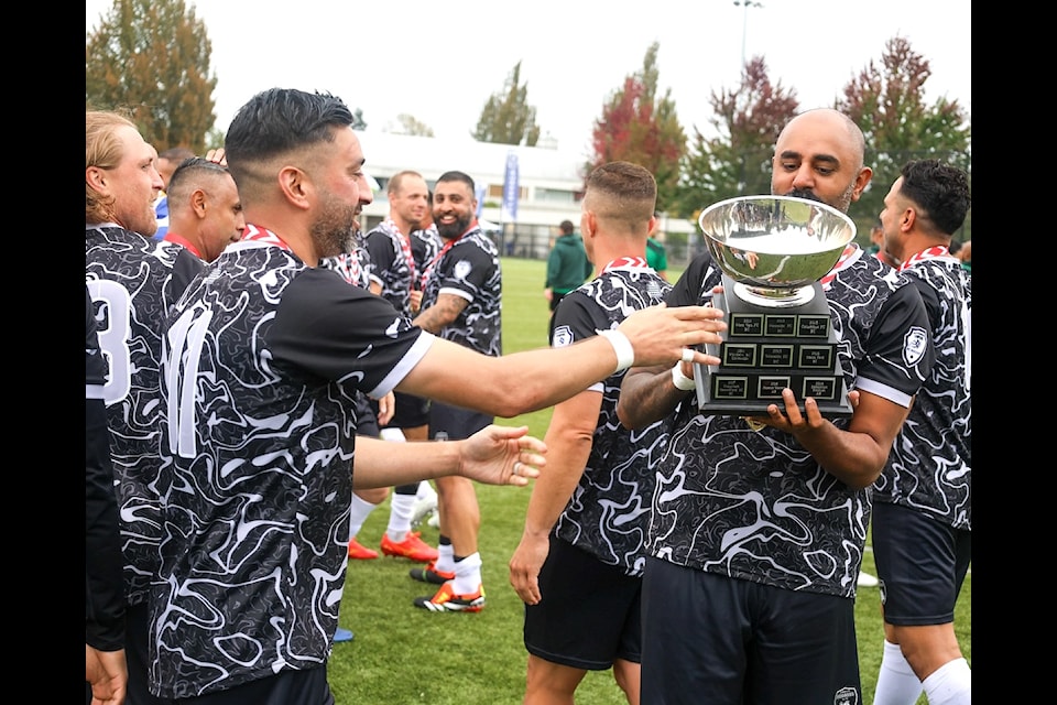 Surrey FC men's soccer team players celebrate their Masters Championship at Newton Athletic Park on Sunday, Sept. 22.