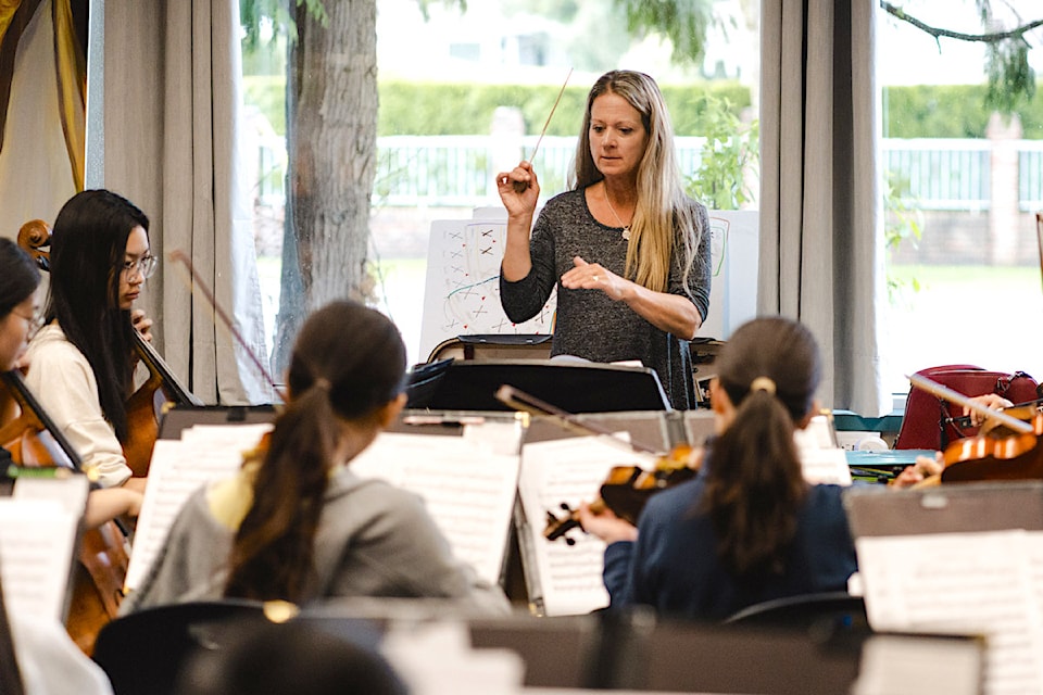 Andrea Lewis-Taylor conducts young musicians with Surrey Youth Orchestra.