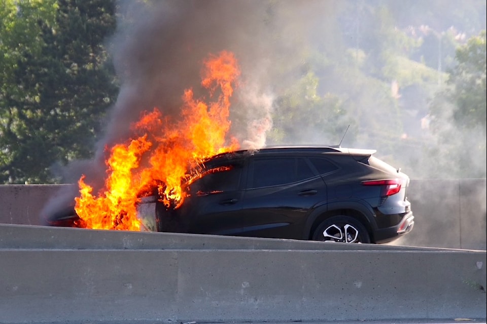 A car burns on Port Mann Bridge Tuesday, June 10, 2025.