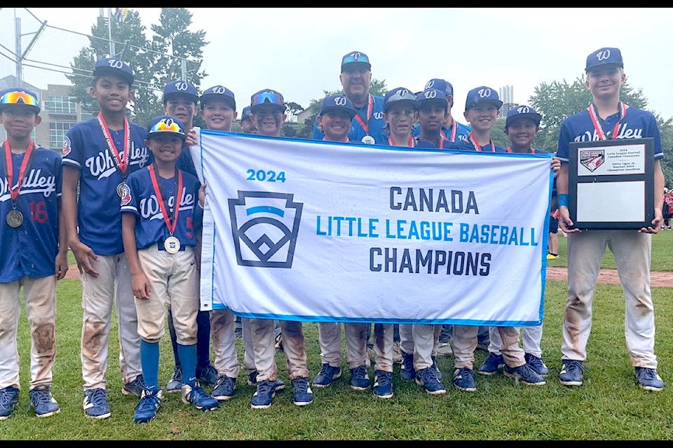 Whalley Major Allstars with their Canadian Little League Championship banner at Cricket Field in Kingston, Ont., Thursday, Aug. 8, 2024.