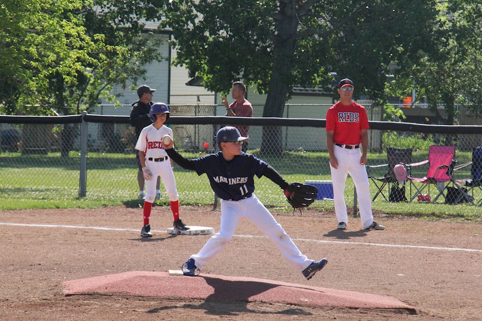 One of the pitchers for Sylvan Lake Mosquito Mariners winds up to dilvers a strike during the Mariners first game of the weekend on July 22. The Mariners played three games over the weekend, all of which are regular season games. Photo by Megan Roth/Sylvan Lake News