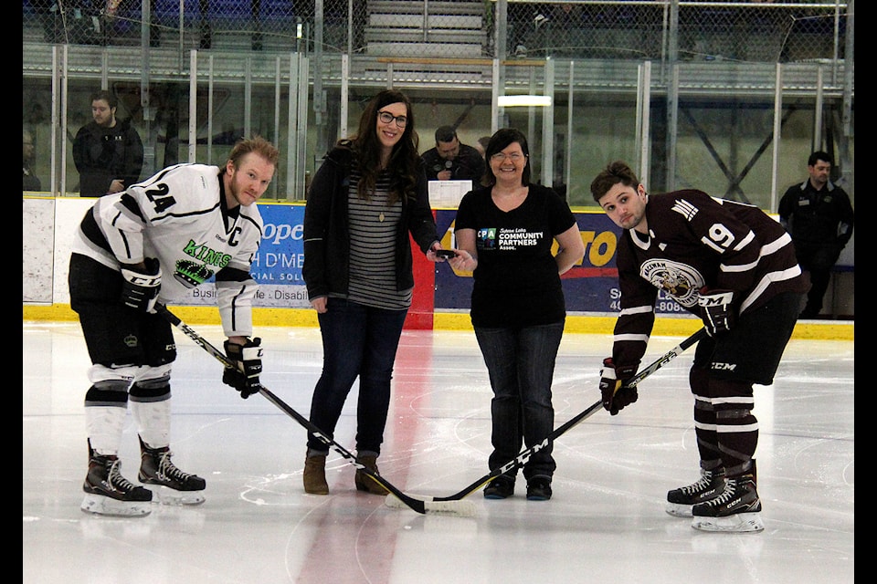 Megan Chernoff Hanson (centre left) and Jen Baliant (centre right) dropped the puck together during the ceremonial face-off at the Kings-Griffins game at the NexSource Centre on Feb. 22. Proceeds from the game were donated to Sylvan Lake and Area Community Partners as the game’s Charity of Choice. Photo by Megan Roth/Sylvan Lake News