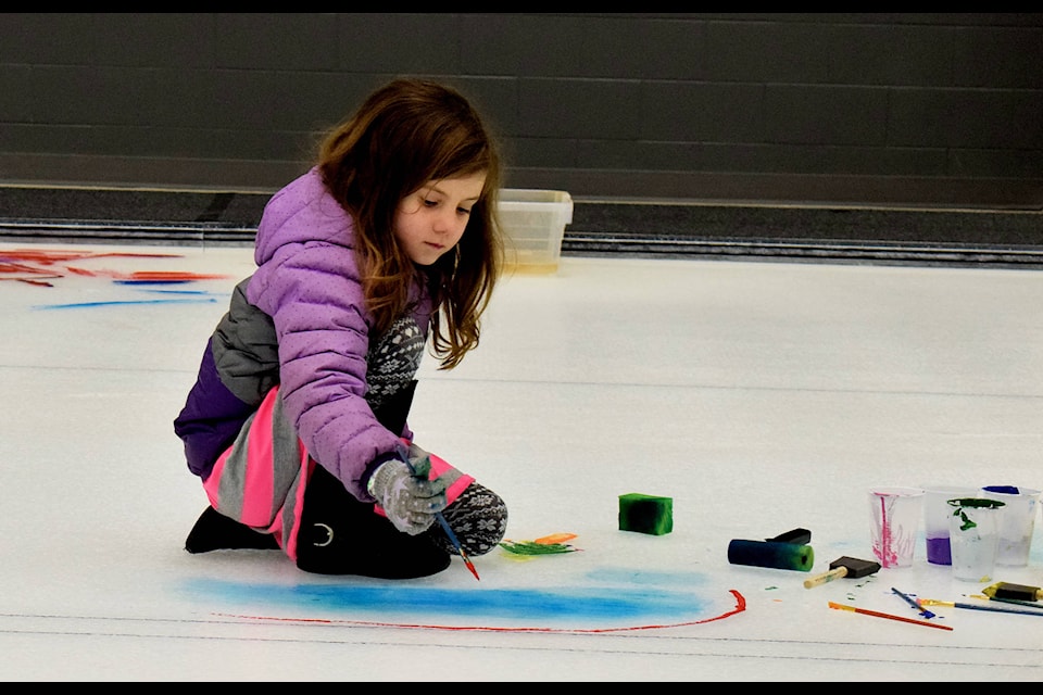Zoeigh Lenfesty-Greenwood, six, paints the beginnings of a rainbow on the curling ice at the NexSource Centre on March 23. Paint the Ice was one Sylvan Lake’s new events to say goodbye to the winter season and celebrate the arrival of spring. Photo by Kaylyn Whibbs/Sylvan Lake News