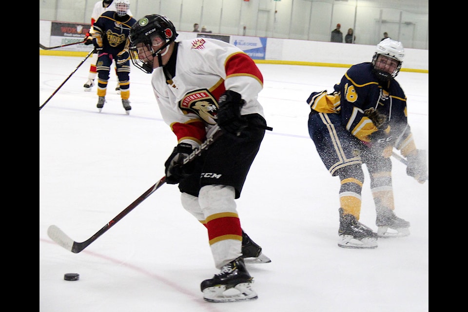 Reid Christiansen moves around a player from St. Albert during the championship game on March 27 before taking a shot on net in the first period.