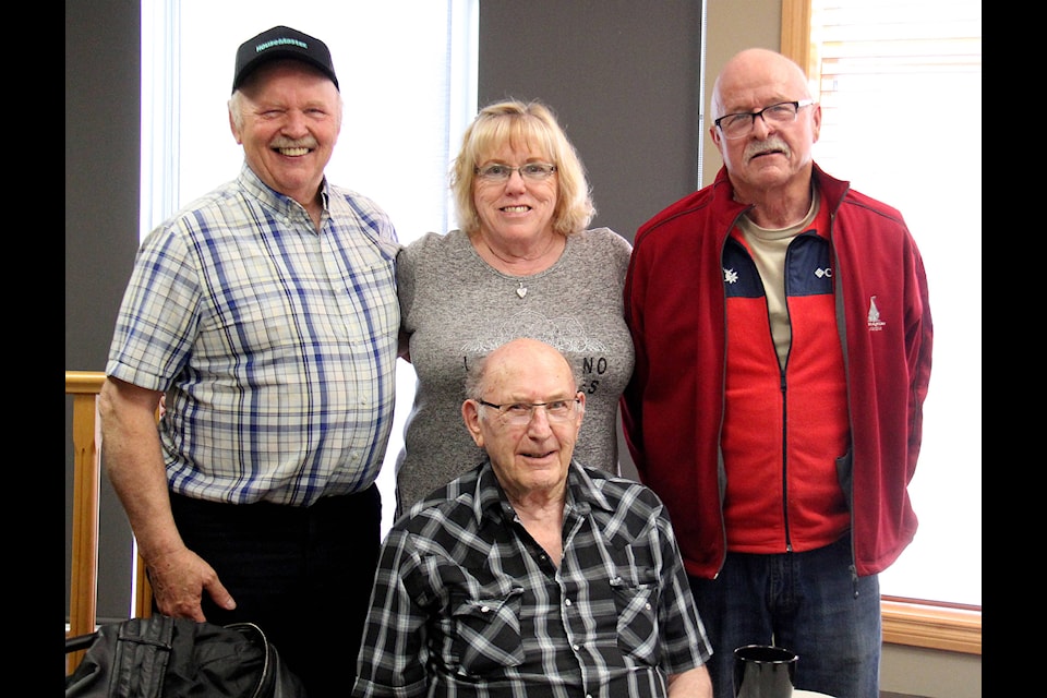 The four drivers with the Sylvan Lake Senior’s Bus Association, Dick Swarbrick (left), Judy Scanland, Dave Dale and Don Lanterman (seated) pose for a photo together at Lanterman’s retirement celebration.